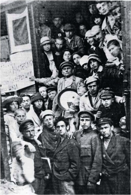 维帖布斯克火车站的画会成员, 1920年6月5日, 黑白照片。第一排左起: Ivan Gavris (靠在他肩上者为Iosif Baitin)、Yakov Abarbanel、 Lazar Khidekel、 Moisei (Mikhail) Kunin、 Moisei (Mikhail) Veksler (右领上有画会标志)。 第二排左起: Nina Kogan (戴草帽者)、 L. L. Zuperman、 El Lissitzky (衬衫袖口上有画会标志)、Ilya Chashnik (穿白色外罩戴帽者)、 Efim Royak。在Chashnik上方者为Efroim (Arkady) Volkhonsky。Volkhonsky 正上方为Vera Ermolaeva (微笑者); Ermolaeva右侧为Evgenia Magaril。中间: Kazimir Malevich。Malevich左上方为Natalya Ivanova (一只手搭在Malevich的胳膊上); Ivanova右侧为Lev Yudin (手搭在她肩膀上)。 Yudin上方为Chaim Zeldin （翻领上有画会标牌)。Malevich肩膀右上为Fanya Belostotskaya (戴白帽者)。 右上角第二位为Lev Tsiperson。