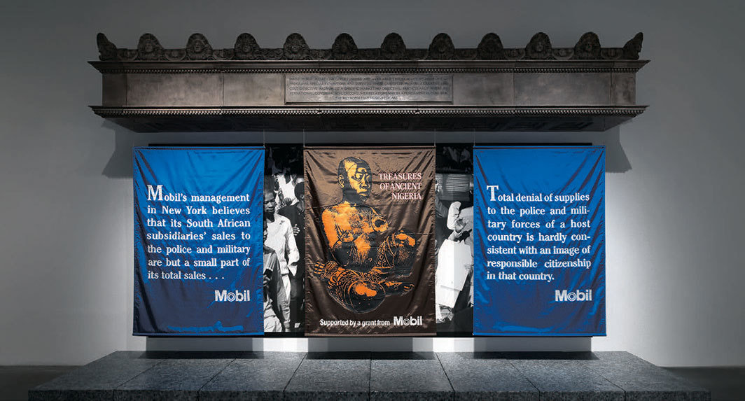 汉斯·哈克，《美孚大都会》，1985，玻璃纤维、三条横幅、照片墙，11' 8" × 20' × 5' 9”. 展览现场，2019. 