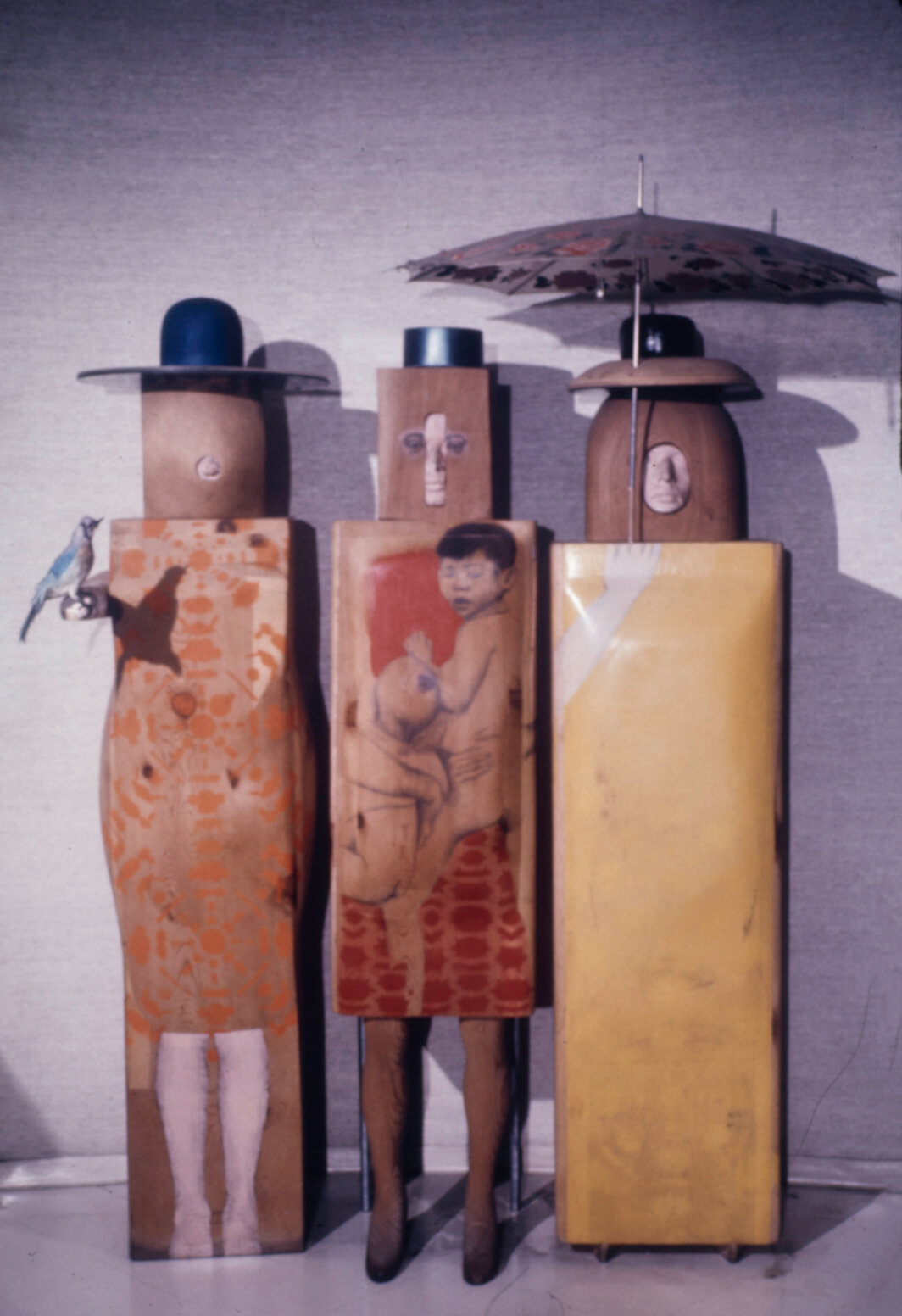 玛丽索，《三个女人和伞》，1965–66，用石墨和颜料涂染的木料、有机玻璃、拾得的塑料伞、毛绒小鸟，81 × 57 × 34".